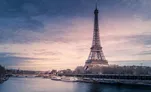 The Eiffel Tower at sunset, seen across the Seine